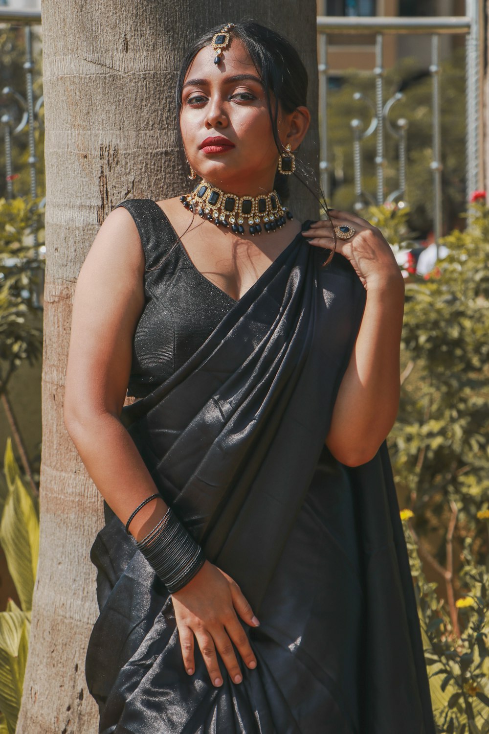 woman in black sleeveless dress wearing silver necklace