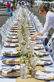 person holding clear glass bottle with water