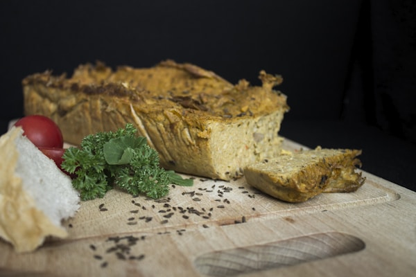 Sliced bread with green vegetable on white and brown floral textile