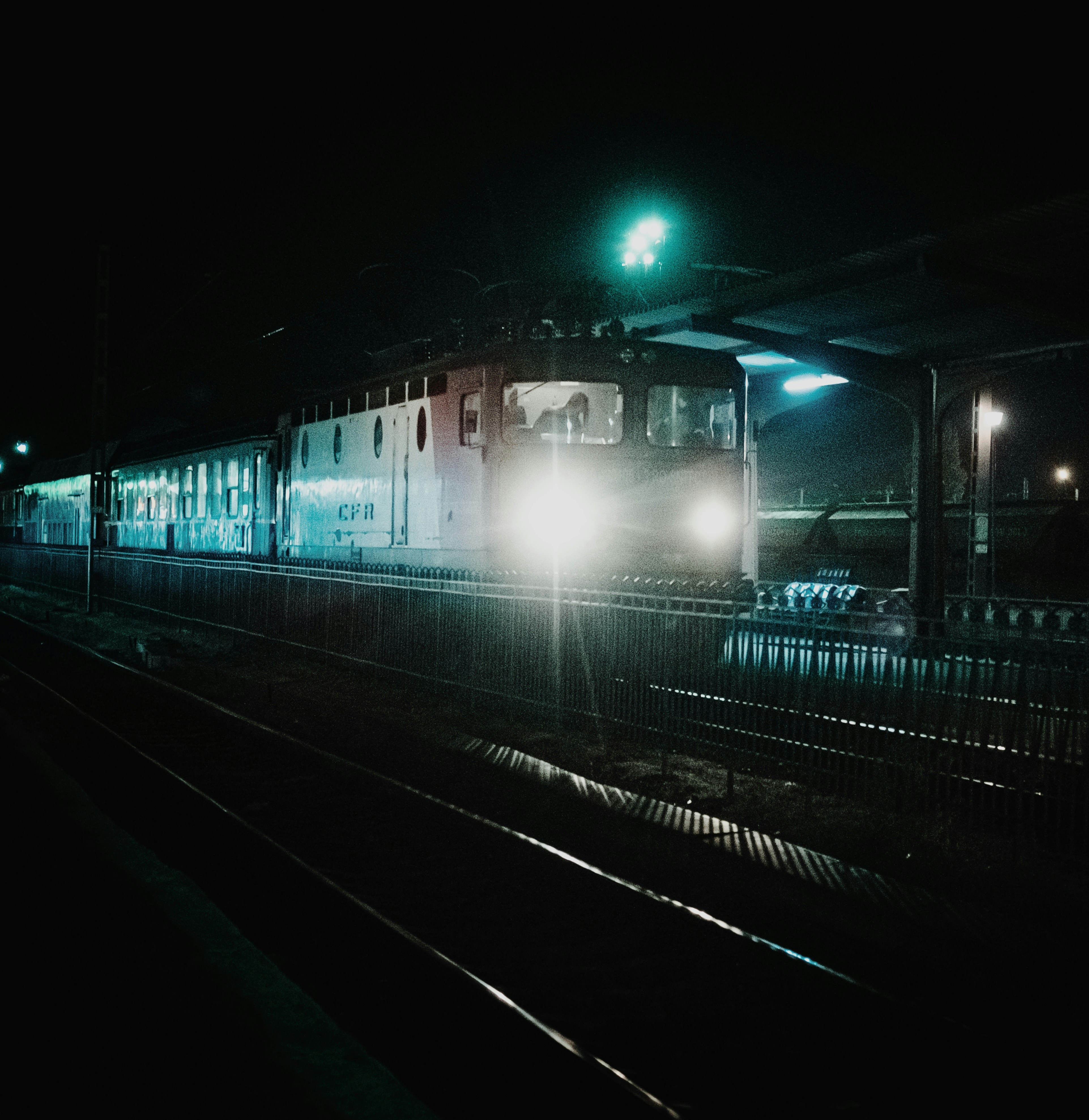train station with lights turned on during night time