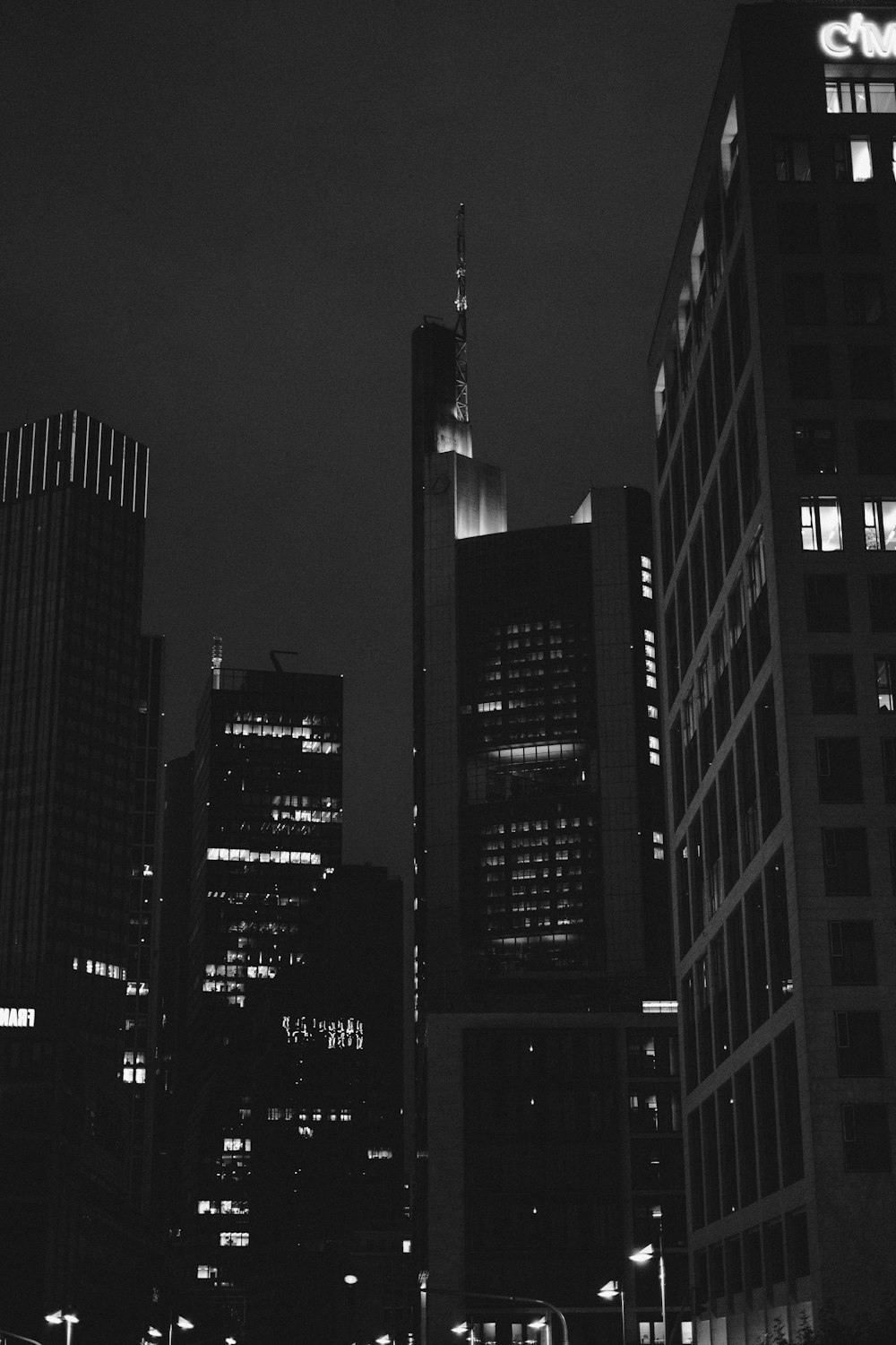 grayscale photo of city buildings during night time