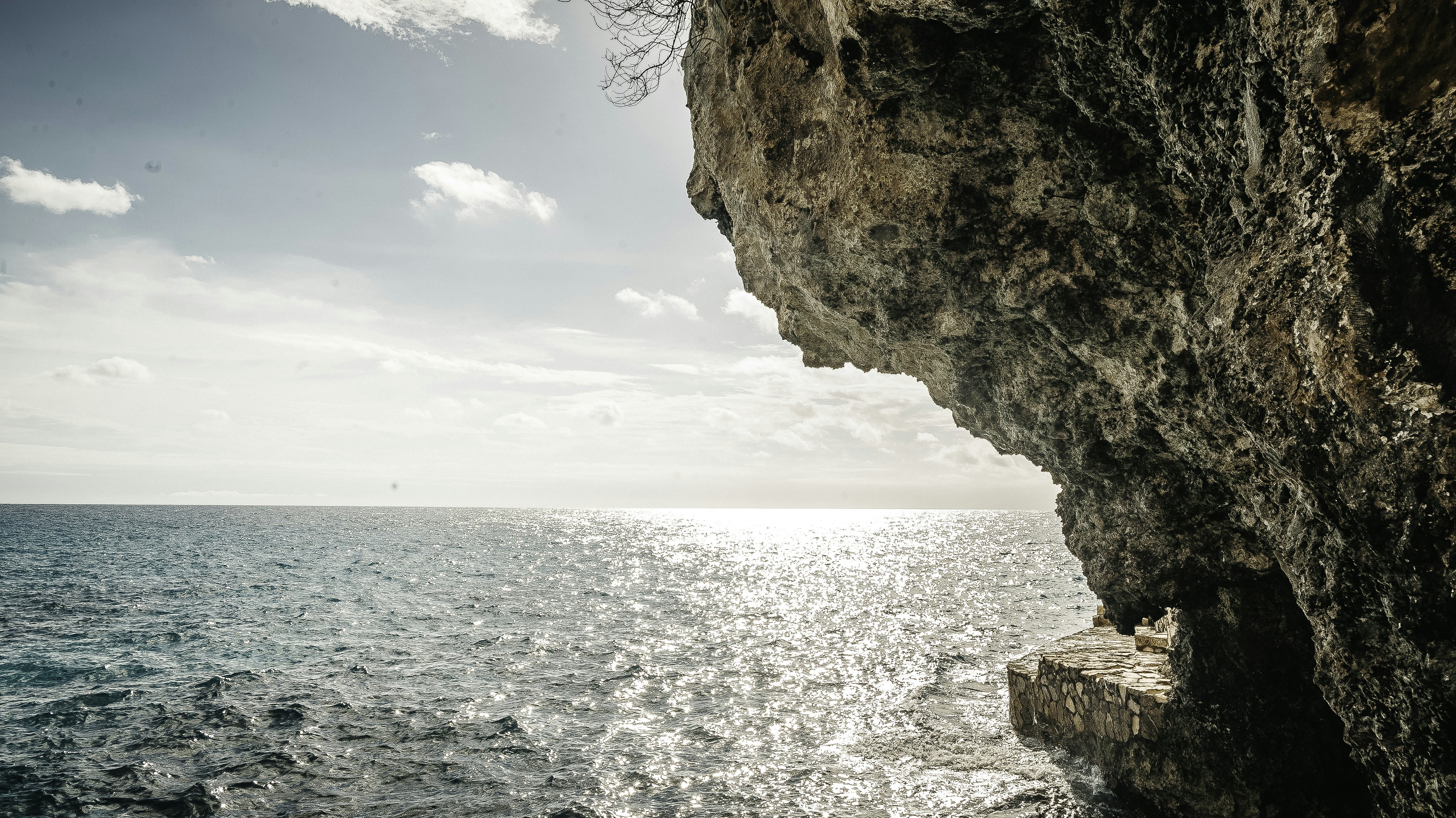 brown rock formation near body of water during daytime