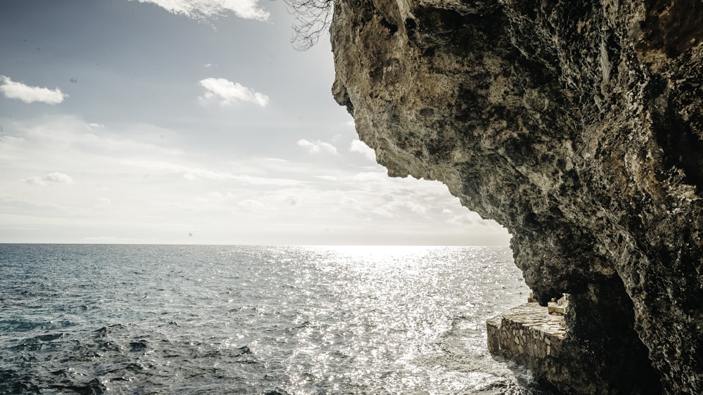 brown rock formation near body of water during daytime