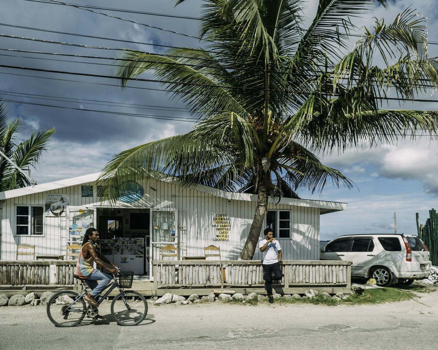 A vibrant Jamaican beach scene with turquoise water and palm trees
