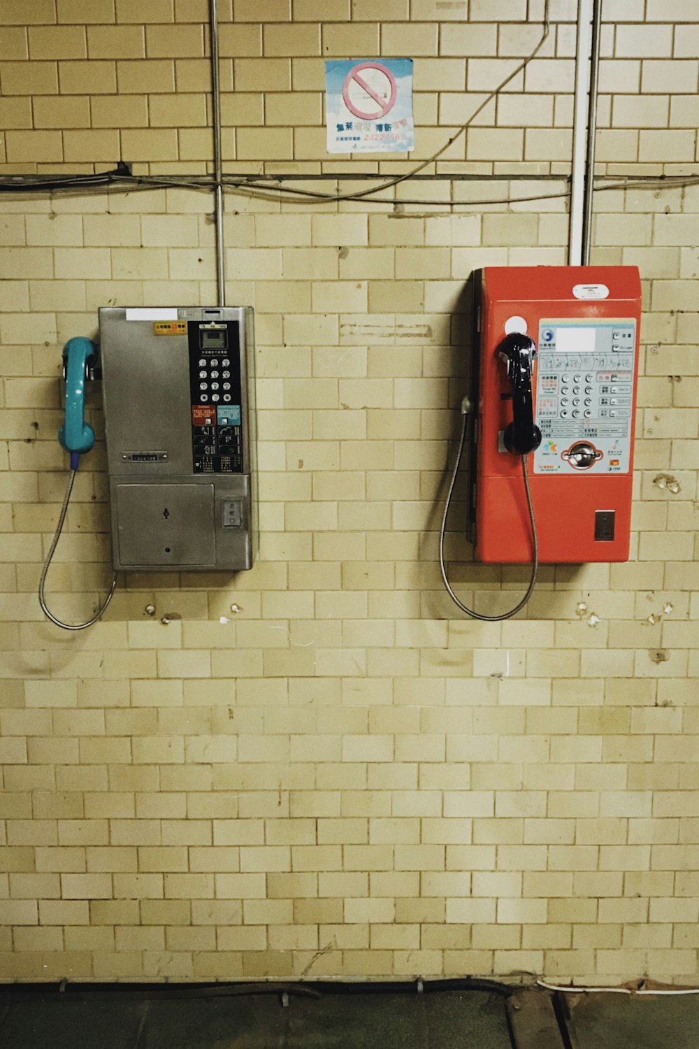 red and black telephone on yellow wall