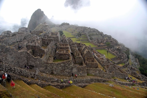 Group of travelers exploring the Sacred Valley with a local guide pointing out landmarks.