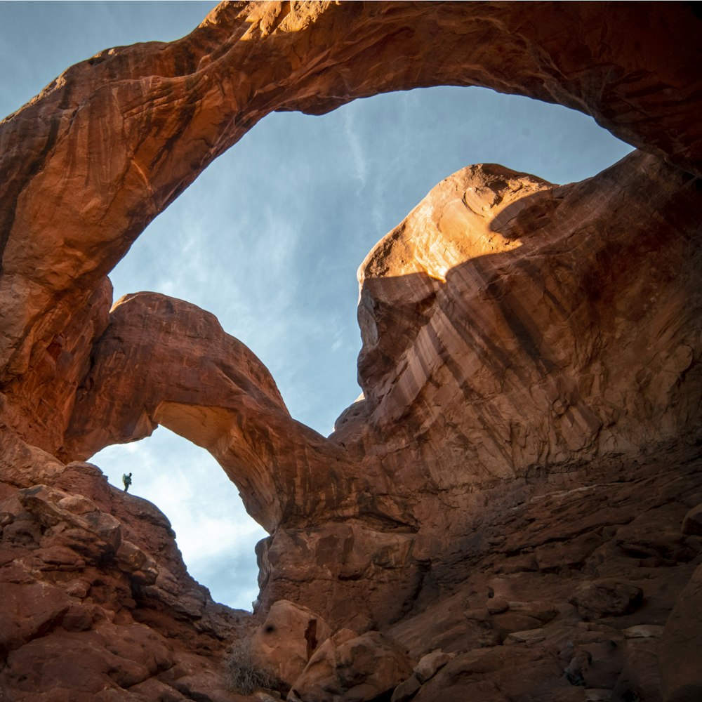 brown rock formation under white clouds and blue sky during daytime