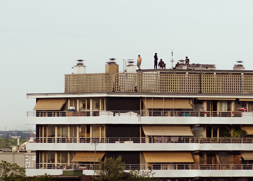 people walking on the street near white concrete building during daytime