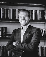 man in black suit jacket smiling