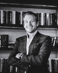 man in black suit jacket smiling
