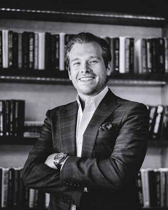 man in black suit jacket smiling