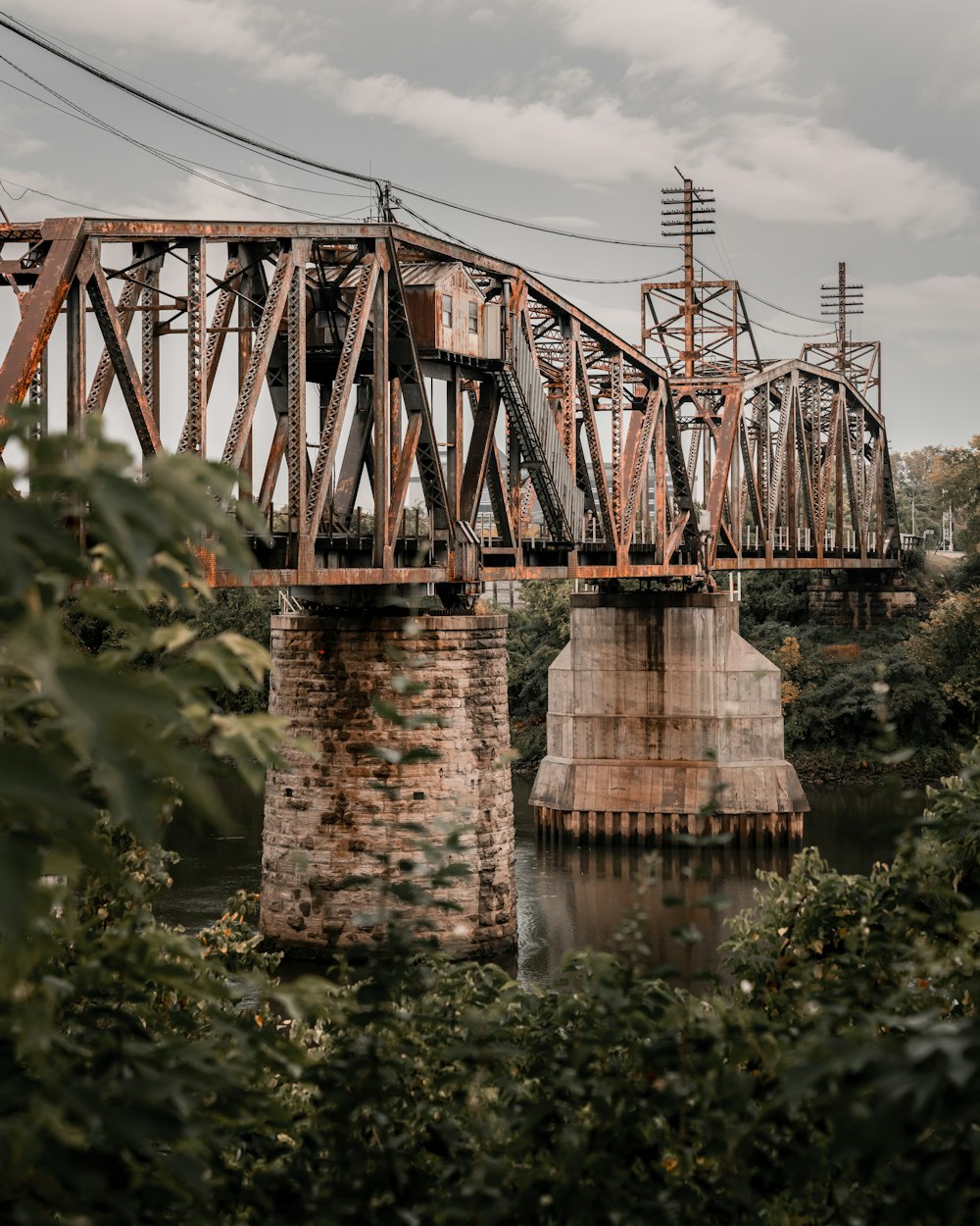 brown and black metal bridge over river