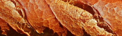 Close-up of golden-brown bread crust with crisp texture.