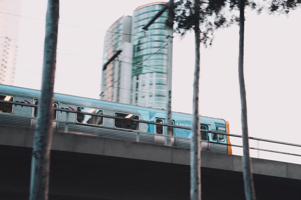 white and blue train on rail