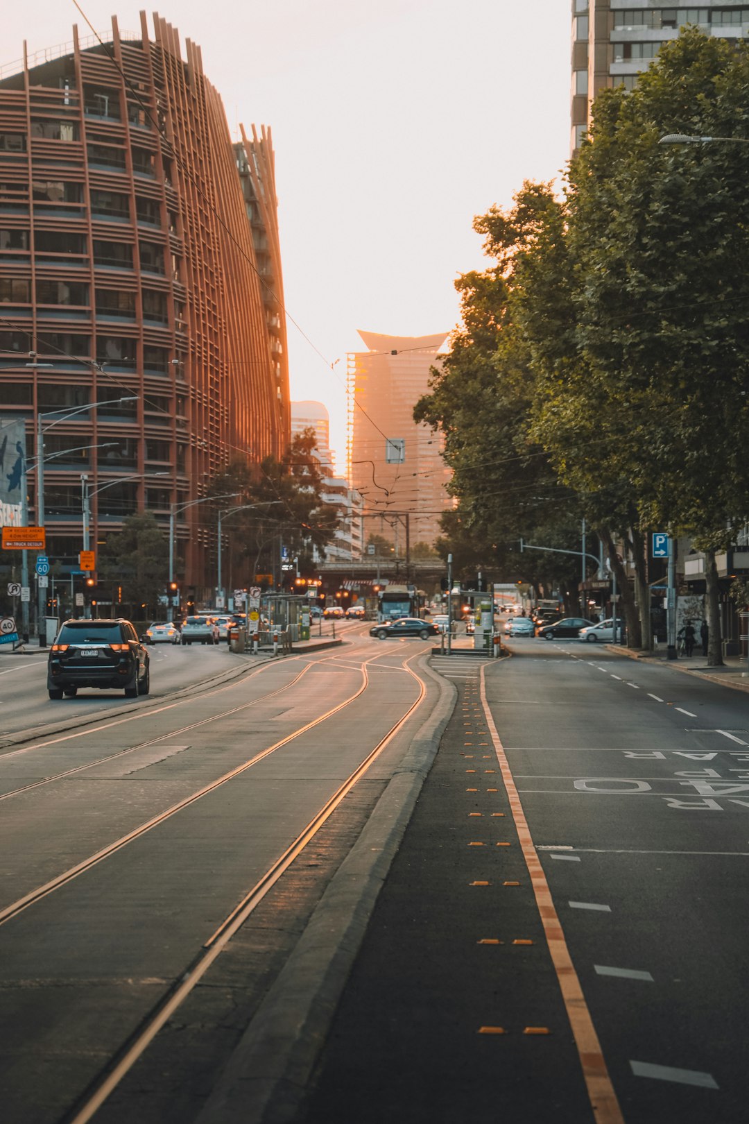 cars on road near brown high rise building during daytime