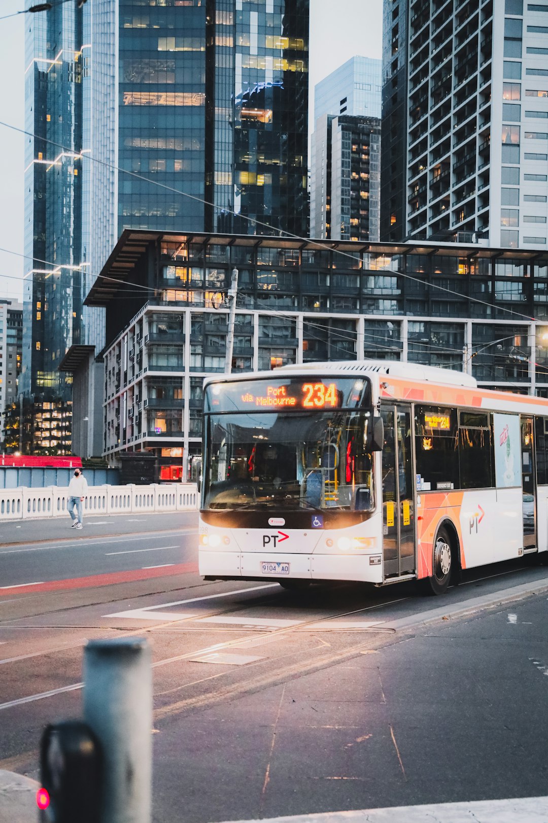 red and white bus on road during daytime