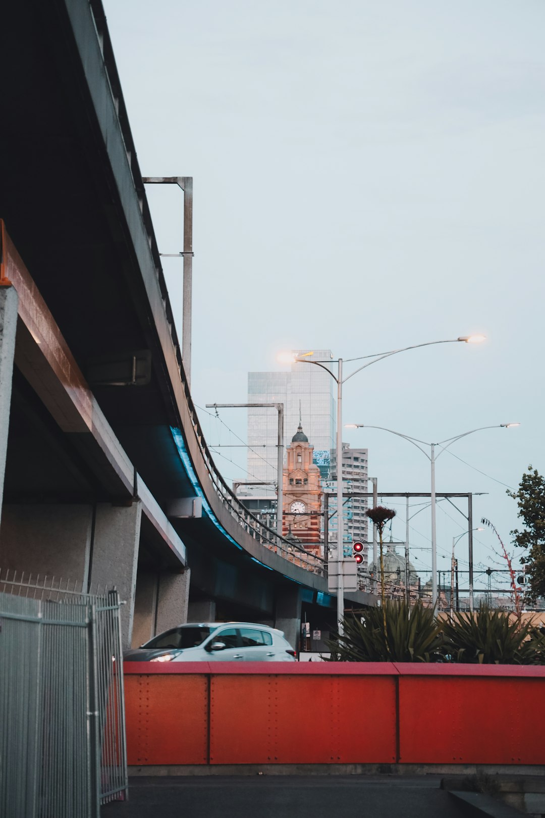 white car parked beside white concrete building during daytime