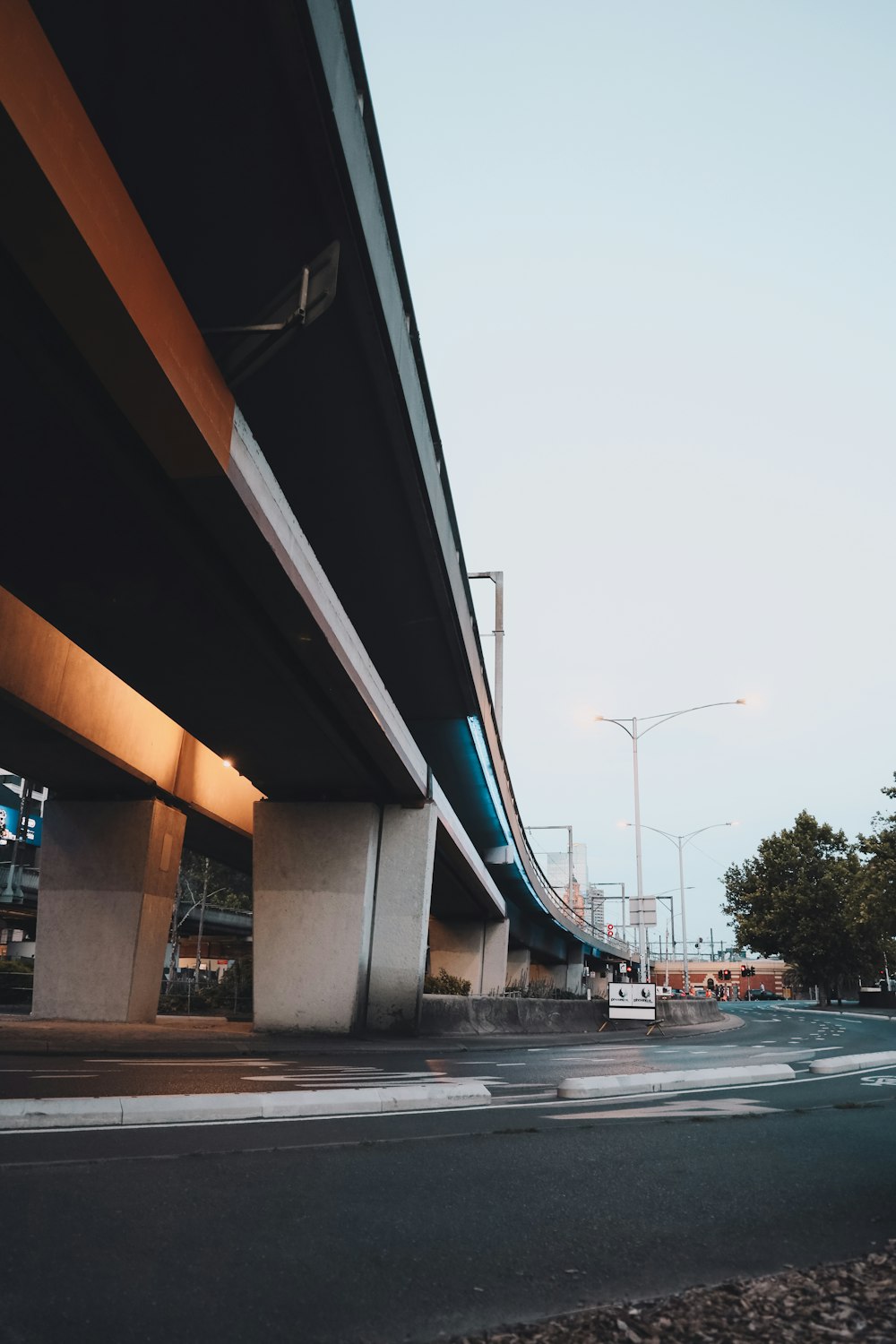 cars on road under bridge during daytime