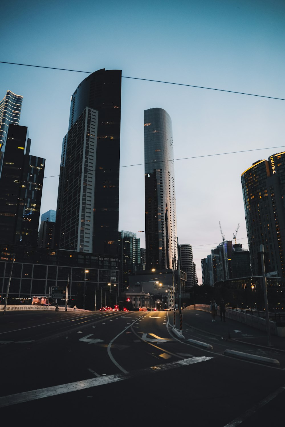 cars on road near high rise buildings during night time