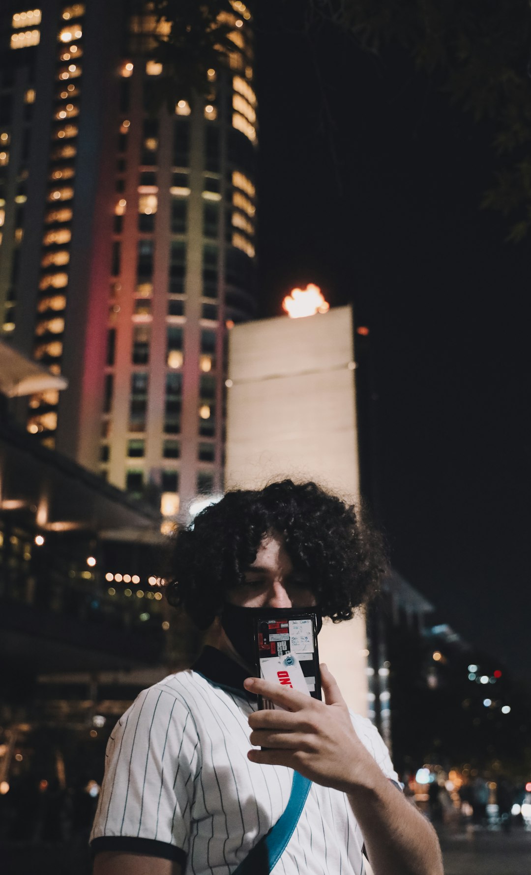 woman in white shirt holding white smartphone