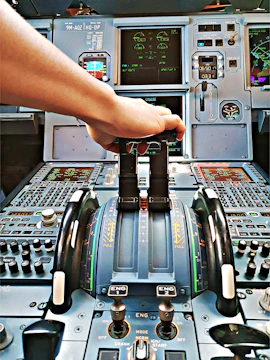 Hands on a realistic flight yoke and throttle controls.