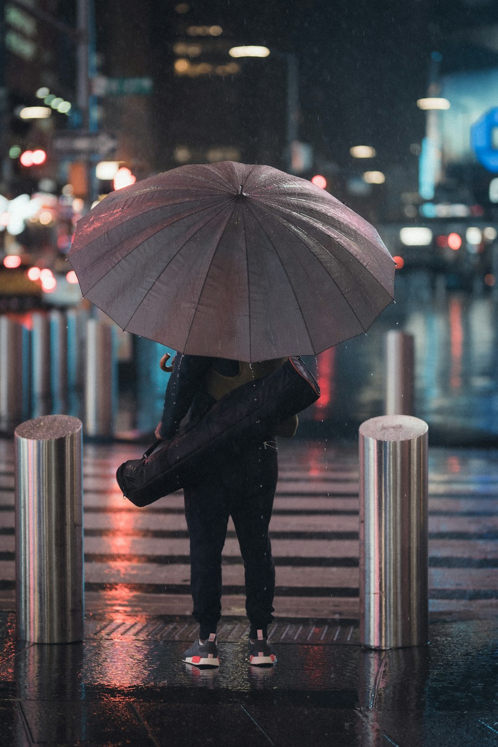 person in black jacket holding umbrella