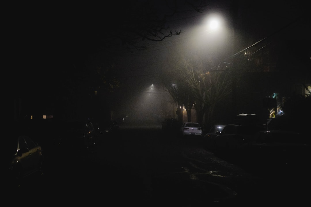 white car parked near light post during night time