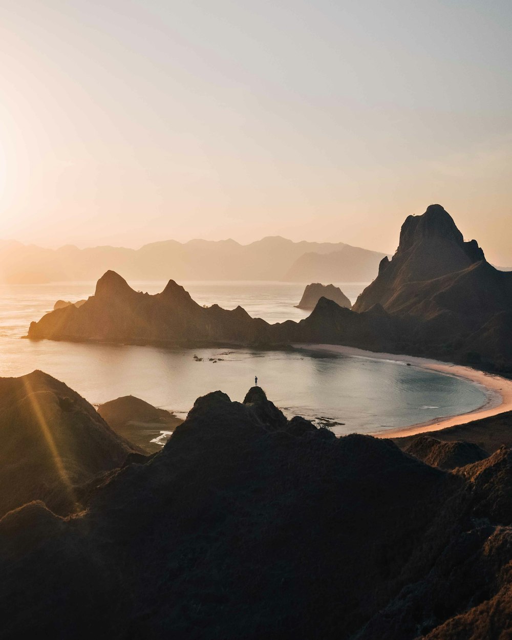 black rock formation on sea during daytime