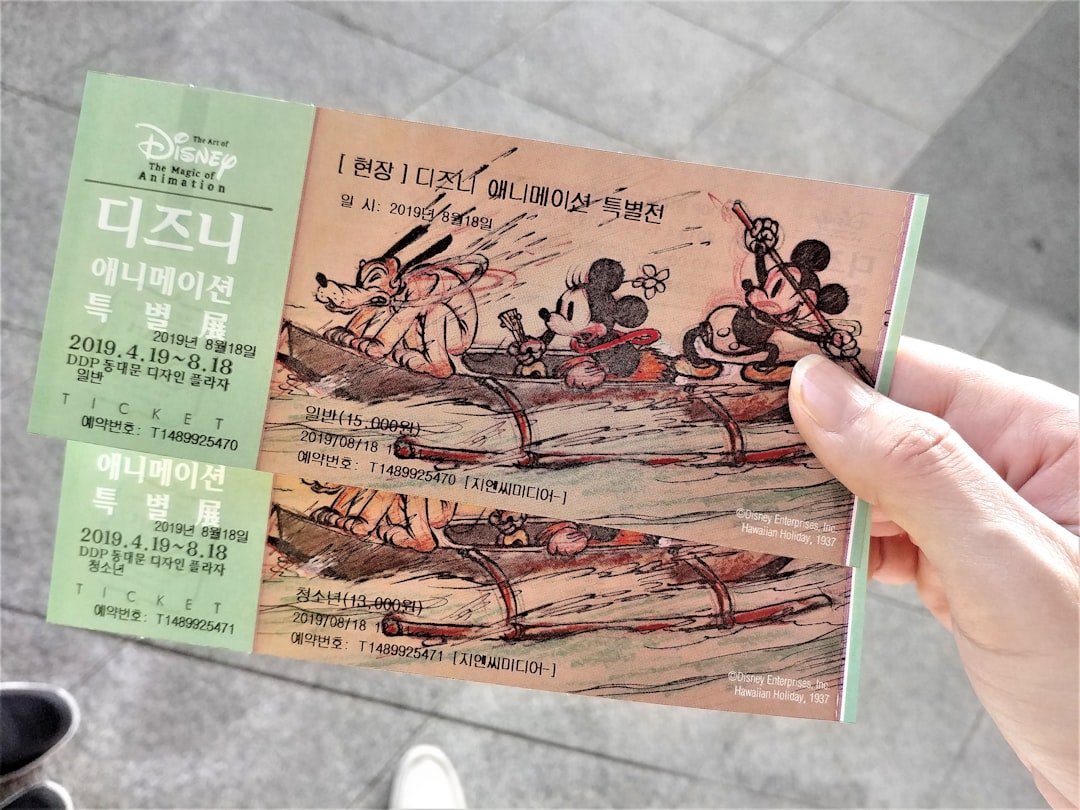 person holding brown and green book,