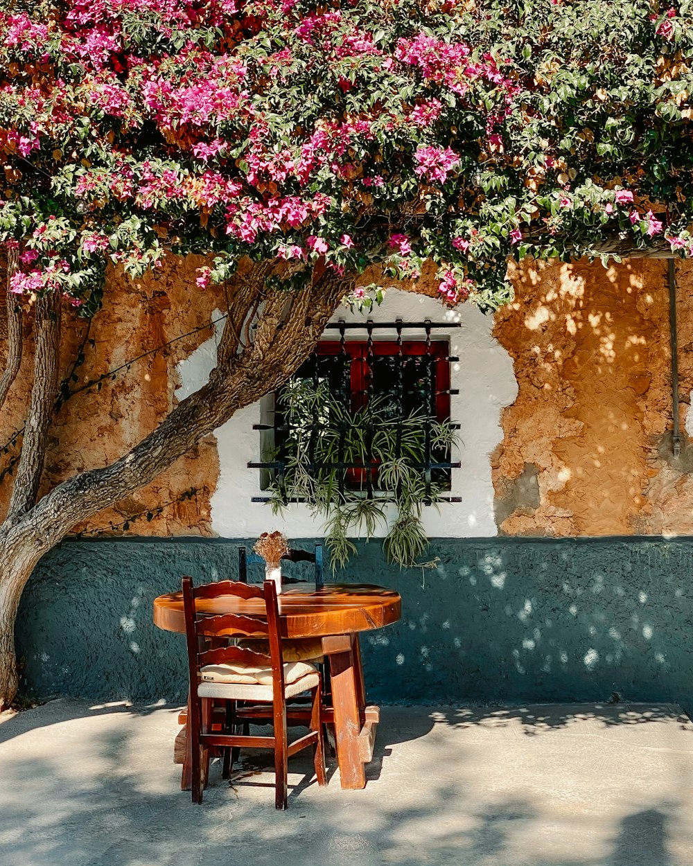 brown wooden chair beside brown concrete wall