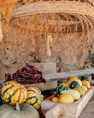 Handcrafted decorative items made from dried totomoxtle leaves displayed on a rustic wooden table.