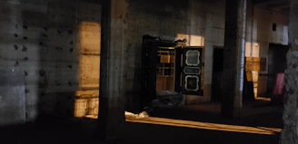 A sleek, dimly lit vault door slightly ajar revealing glimpses of luxury items inside.