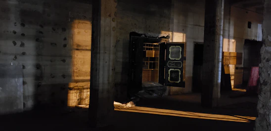 A sleek, dimly lit vault door slightly ajar revealing glimpses of luxury items inside.