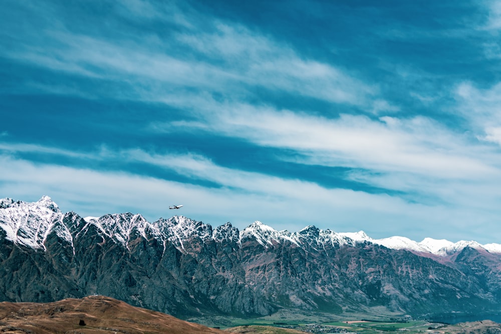 snow covered mountain under cloudy sky during daytime