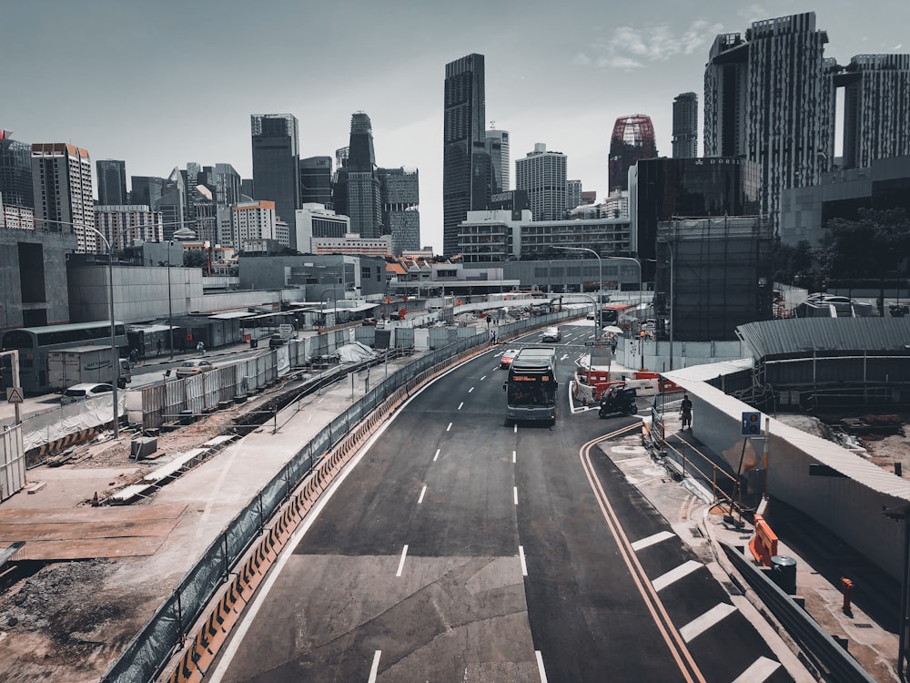 cars on road near city buildings during daytime