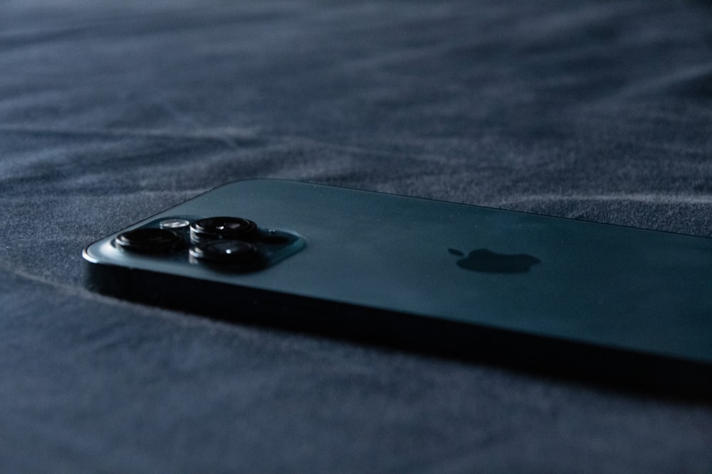 black iphone 4 on gray textile