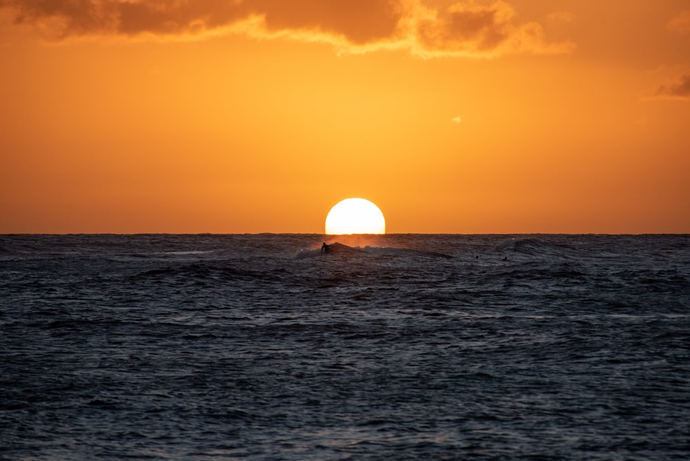 body of water during sunset