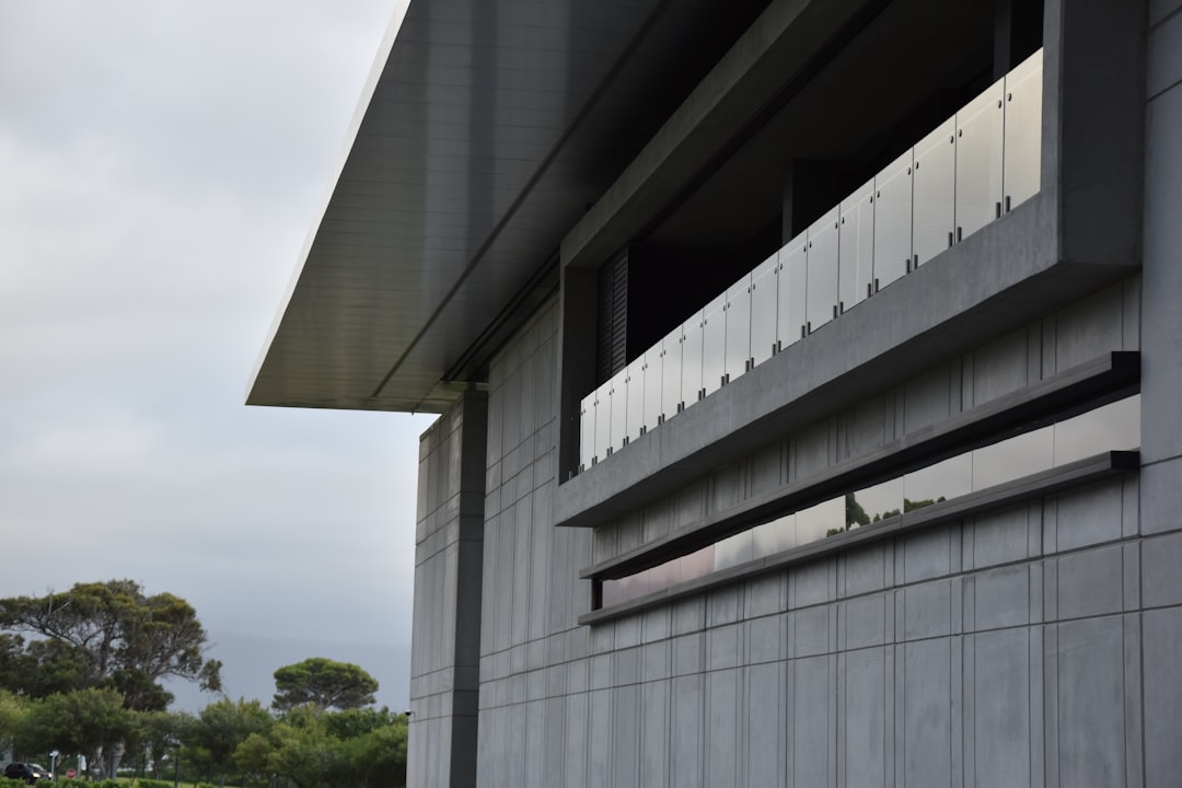 white concrete building near green trees during daytime