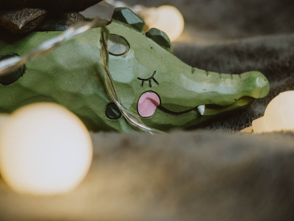 green frog figurine in close up photography