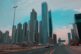 The bustling Business Bay district with modern skyscrapers and busy streets during the day.