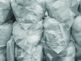 Close-up of clear vacuum bags neatly arranged on a wooden surface.