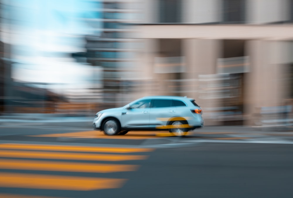 white and yellow sedan on road during daytime