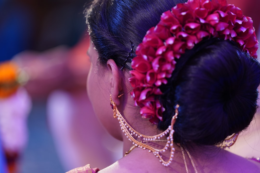 woman in white sleeveless top wearing silver and red floral head band