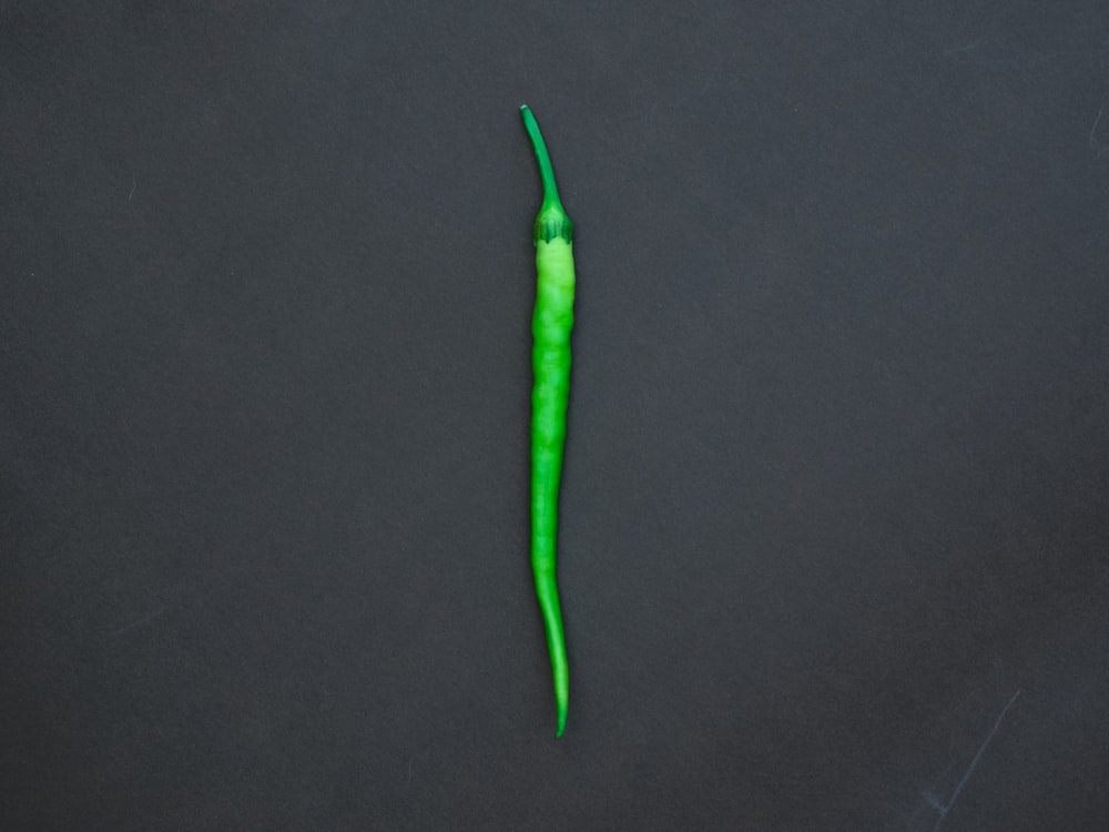 green chili on black textile