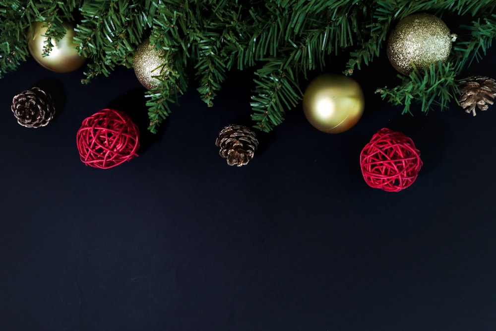 red and gold baubles on green christmas tree