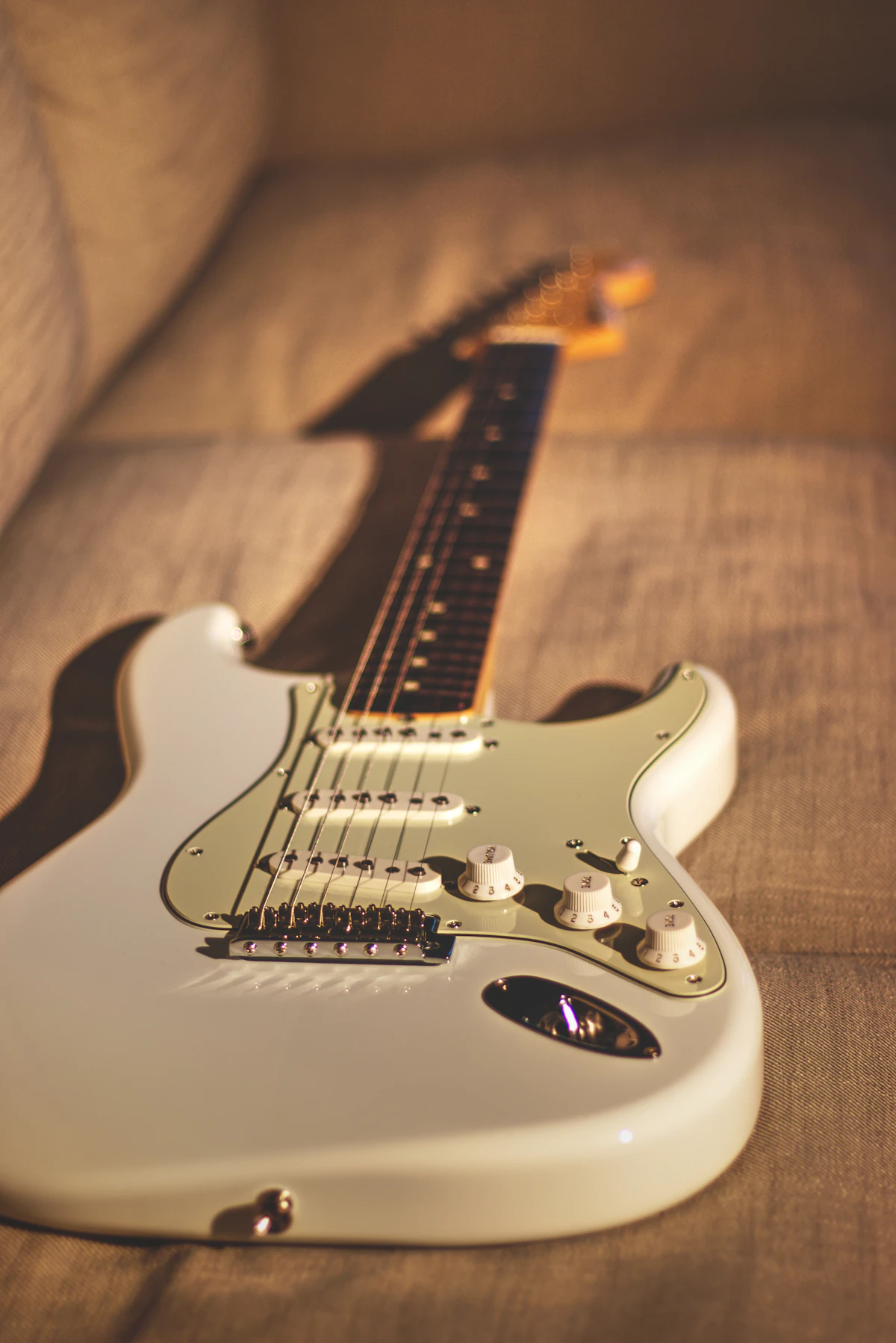 A pristine Olympic-white vintage Stratocaster-style guitar