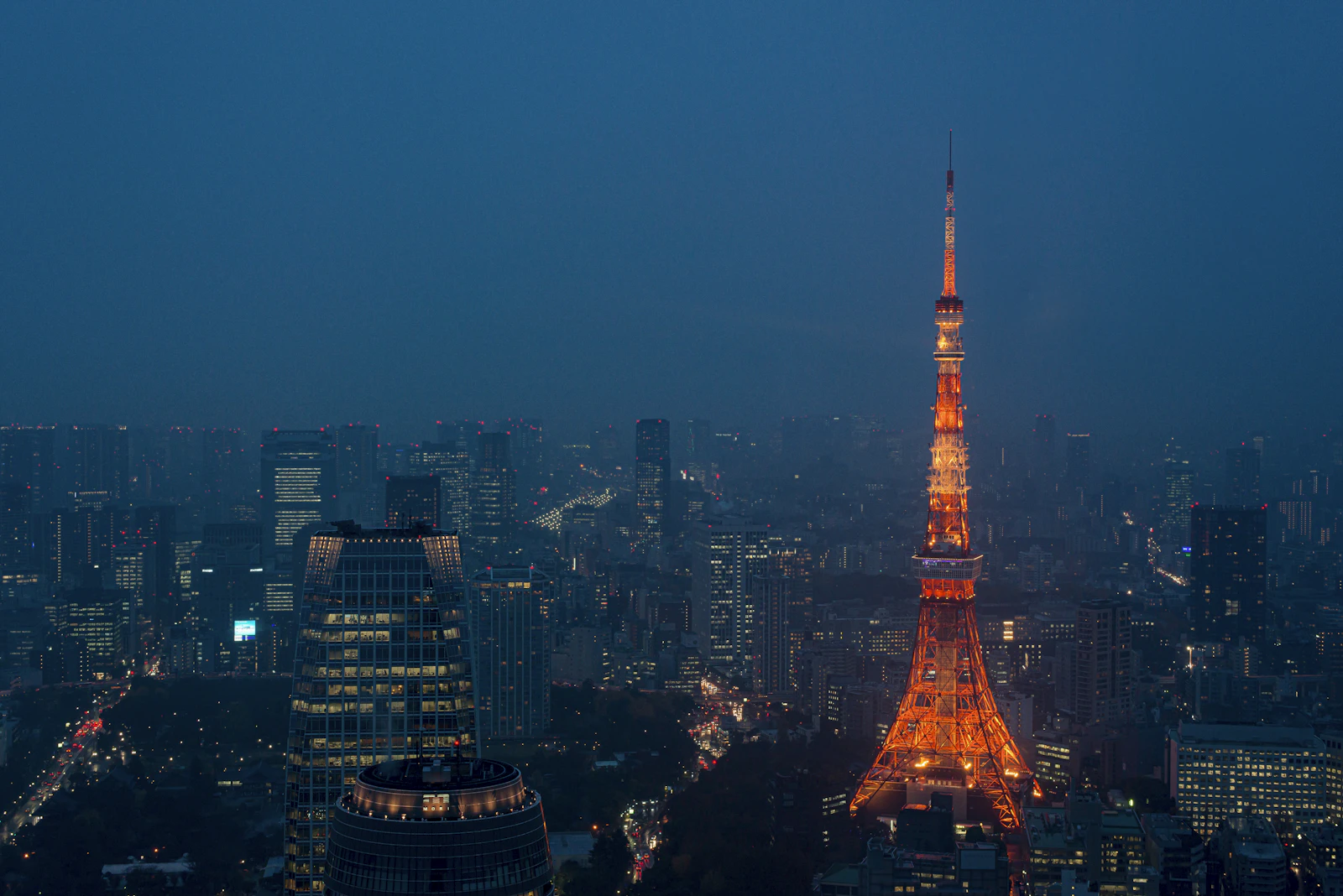 Tokyo Tower glowing above the city skyline at dusk