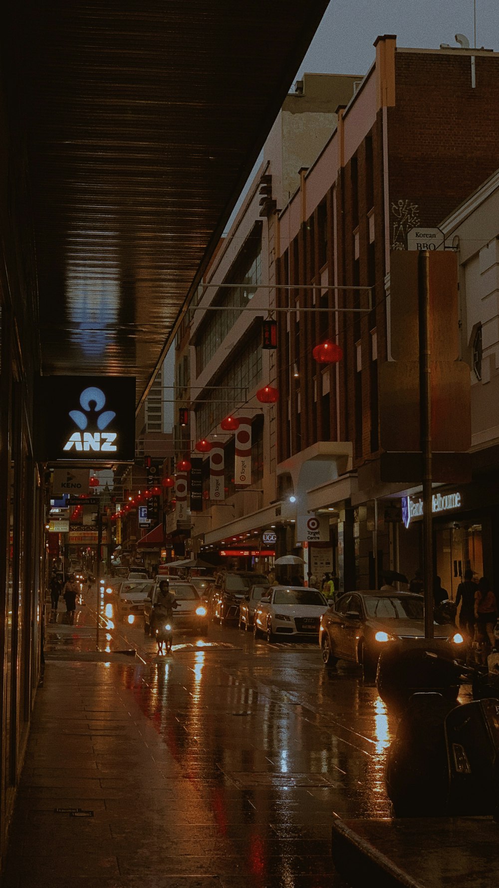 cars on road in between buildings during night time