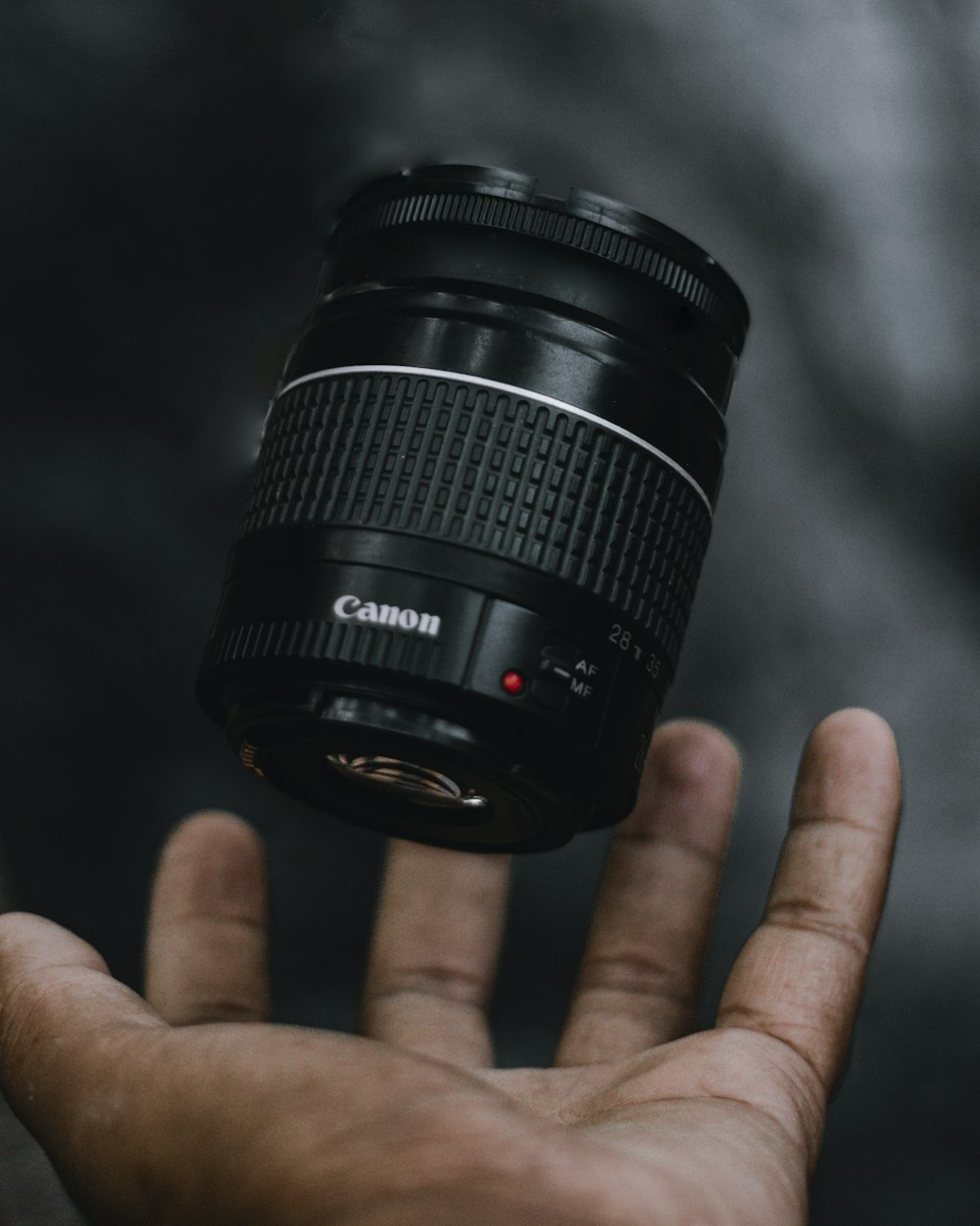 person holding black camera lens