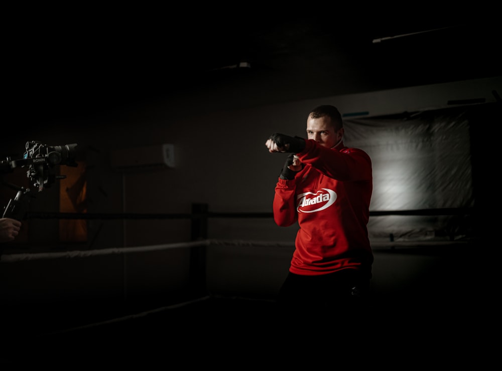 man in red nike crew neck t-shirt and black shorts